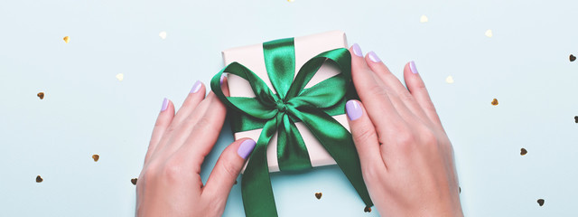 Woman hand holding green gift box for Father's Day. Happy Father's Day holiday greeting card, flat...