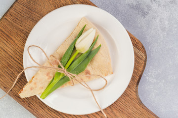 creative peace of pizza with flowers tulips in plate