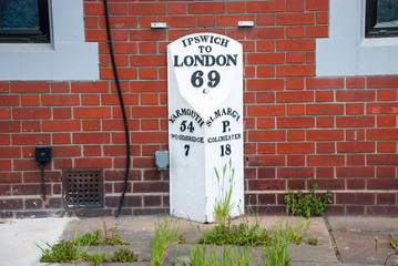 An old milestone marker in showing the distance to London from Ipswich in the UK