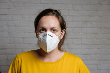 Young woman wearing KN-95 protection medical mask. Prevention of the spread of virus and epidemic, protective mouth filter mask. Diseases, flu, air pollution, corona virus concept