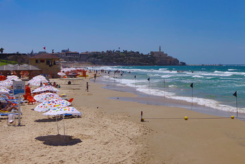 Tel Aviv beach on the background of the Mediterranean Sea and the old city.