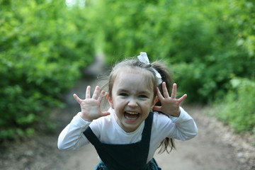 Happy child. Happy little girl found. Child alone in the forest. Unattended child. Тhe little girl was lost alone in the forest. 