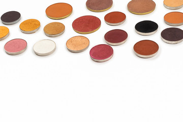 Round multicolored make up eyeshadows isolated on white.