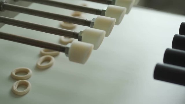 Automatic pretzel making machine. Baking buns on the production line in the baking industry