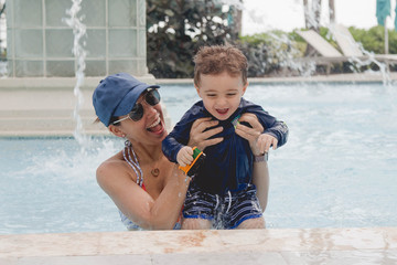 Fototapeta na wymiar Mother and son playing in the pool at the Marriott Stellaris Puerto Rico Condado beach 