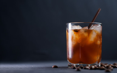 Cold brew iced coffee. Refreshing cold summer drink on a dark table