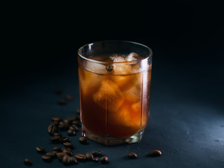 Cold brew iced coffee. Refreshing cold summer drink on a dark table