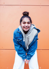 young pretty teenage girl posing cheerful happy smiling wearing street style outside in europe city, lifestyle people concept