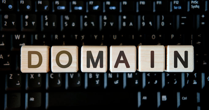 Domain - concept text on wooden cubes on background black keyboard