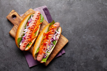 Hot dog with vegetables, lettuce and condiments