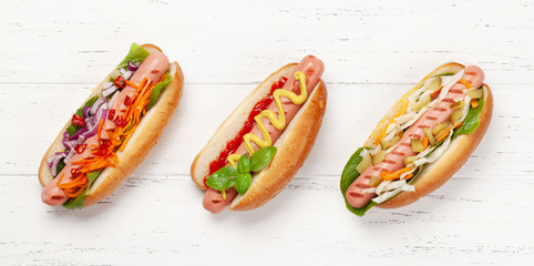 Various hot dog with vegetables, lettuce and condiments
