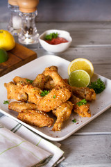 Crispy chicken wings with lemon and sauce