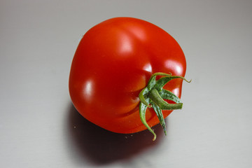 Juicy tomato on a dark matte surface