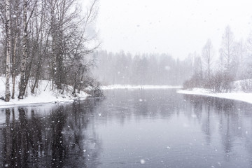 Snowfall idyll. The course of the Kumsa river during snowfall. Republic of Karelia. March 2020
