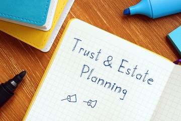 Business concept about Trust & Estate Planning with sign on the sheet.