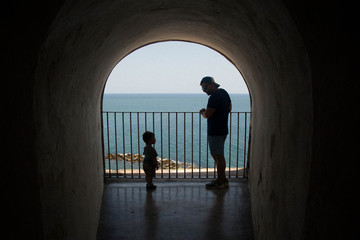 silhouette of father and son walking on the street