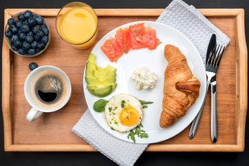 A set of products for a delicious European Breakfast on a wooden tray.