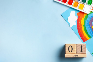  Flatlay wooden calendar June 1, paints, rainbow. June 1, World Children's Day. Copy space