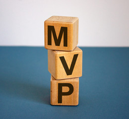 Concept word 'MVP' on cubes on a beautiful blue background. Business concept.