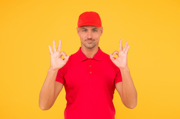 Everything will be OK. Happy guy show okay signs. Guy with ring gestures yellow background. Handsome guy in casual style. Unshaven guy wear red cap and polo shirt. Fashion and style. Menswear store