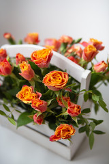 Beautiful little roses in a wooden basket