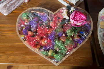 Basket with sweets stands on the table . Engagement accessories . Engagement basket .