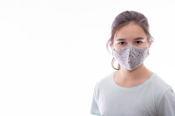 young girl with a gray mask on her face looks forward