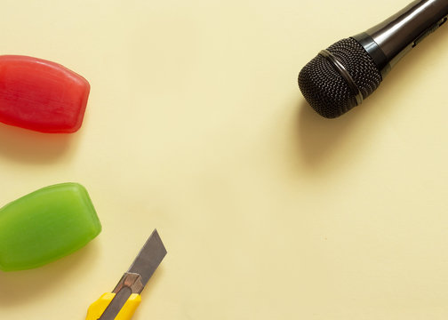 ASMR concept. Specific auditory irritants. Soap and a knife lie in front of the microphone. Top view, flat lay.