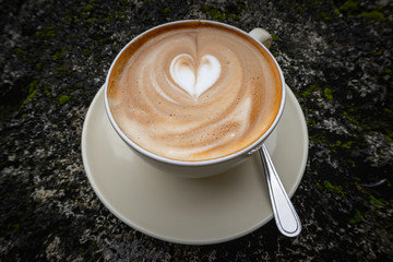 Morning essentials - A cup of Cappuccino with a heart made of milk froth