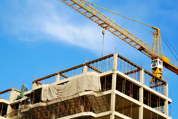 Tower crane and building activity. Construction site background.