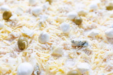 Close up image of cheese pizza ready for baking