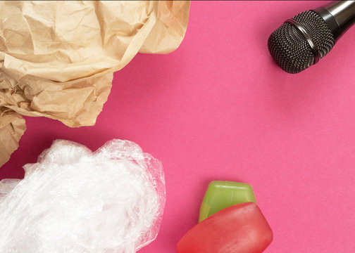 ASMR concept. Specific auditory irritants. Soap, plastic wrap and wrinkled paper lie in front of the microphone. Top view, flat lay.