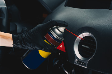 Technician cleaning the air conditioning vents with spray. Maintenance and repair concept of the...