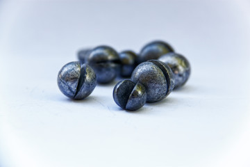 Close up of round ball of metals over a white background