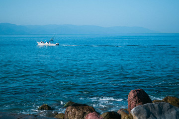 Fishing boat in the pacific ocean out of coast of puerto Vallartas Mexico 