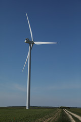 Fototapeta premium Windmill for electric power production, France. Blue sky
