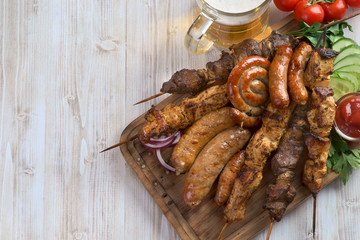 fried sausages and kebabs with a glass of beer