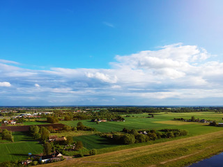 Naklejka premium White clouds on a Sunny day over the village view from a drone.