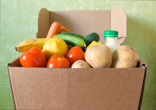 Opened box filled with food stuff. Delivery concept. Safe online shopping. Copyspace. Indoors.