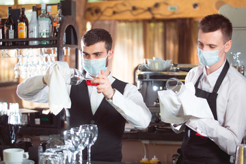bartender is working at the bar in the restaurant.