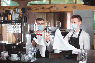 bartender is working at the bar in the restaurant.