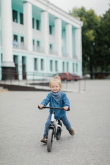 little girl rides on a runbike. Children's sports. rest with a child