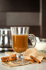 Coffee in a glass cup and cinnamon