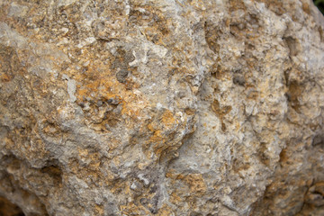 the surface of a yellow stone with a brown tint
