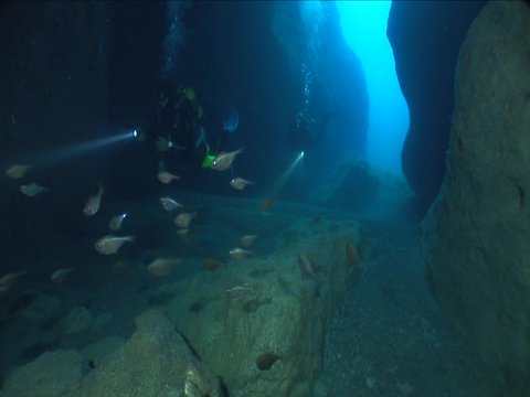 cave diving underwater scuba divers exploring caves ocean scenery