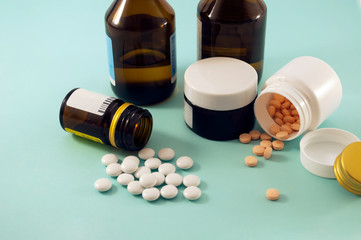 jars with pills and solution on blue background