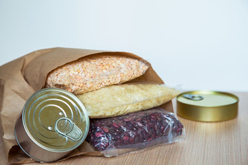 a set of delivery products, cereals and a tin can, on a wooden table