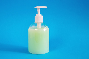 Plastic bottle with detergent on a blue background.