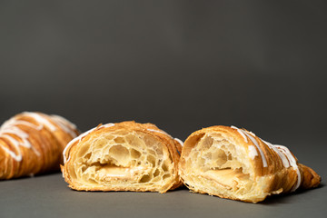 Photo of a traditional freshly baked croissant filled with a delicious white chocolate cream.