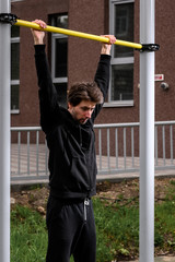 Fototapeta premium athlete performs an exercise on the crossbar